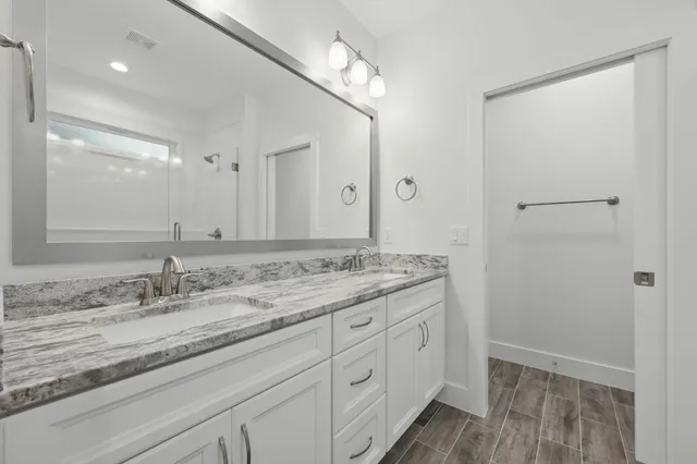 a bathroom with a shower and a glass door