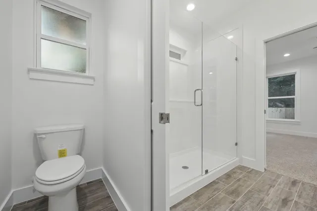 a bathroom with a granite countertop sink a large mirror and a shower