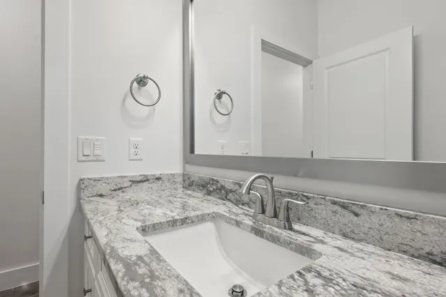 an empty room with a chandelier fan