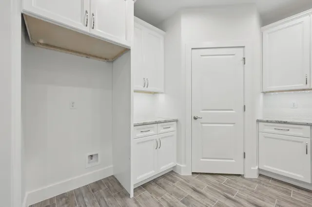 a large white kitchen with kitchen island a sink counter space and appliances