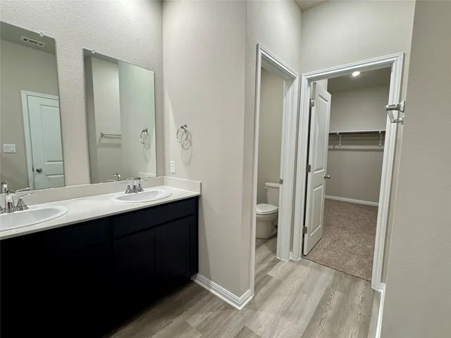 a bathroom with a sink mirror and shower