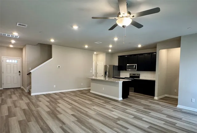 a view of kitchen with microwave stove top oven and cabinets