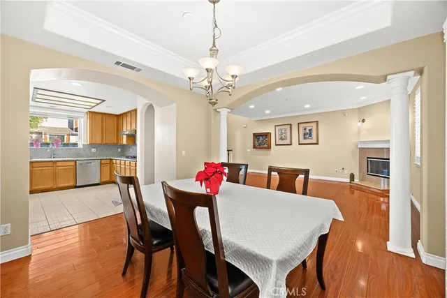 a kitchen with stainless steel appliances granite countertop a refrigerator a sink dishwasher and wooden cabinets with a large window