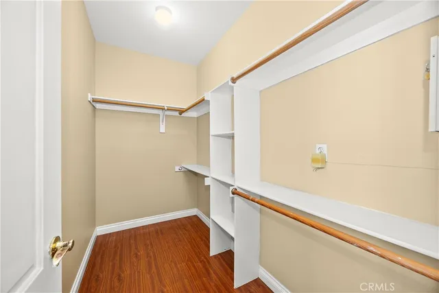 a bathroom with a granite countertop double vanity sink a mirror and a bathtub