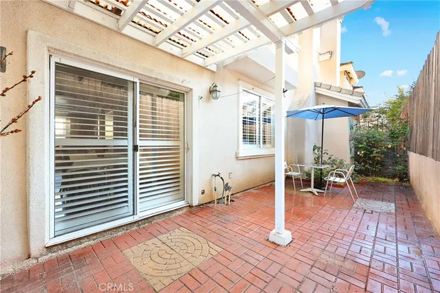 a view of balcony with furniture and umbrella