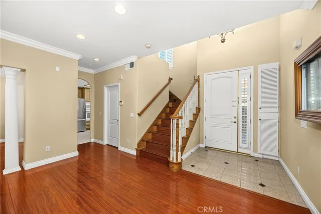 a view of a livingroom with wooden floor and a fireplace