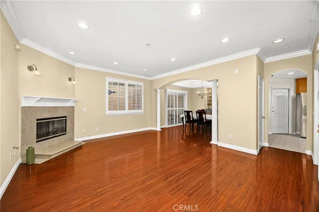 a view of an empty room with window and fire place