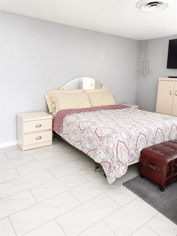490 Water Road Ocala, FL 34472 - Photo 11 of 12 a bedroom with a bed and a lamp on the dresser