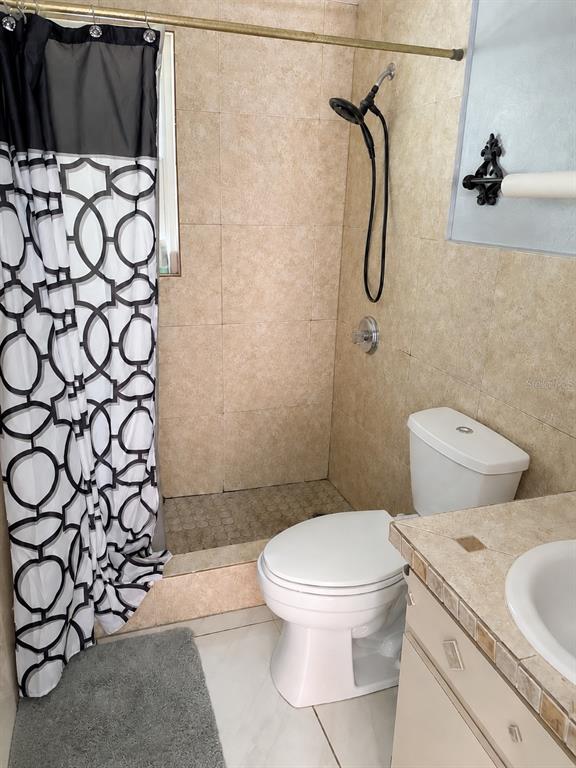 490 Water Road Ocala, FL 34472 - Photo 12 of 12 a bathroom with a toilet and a shower curtain