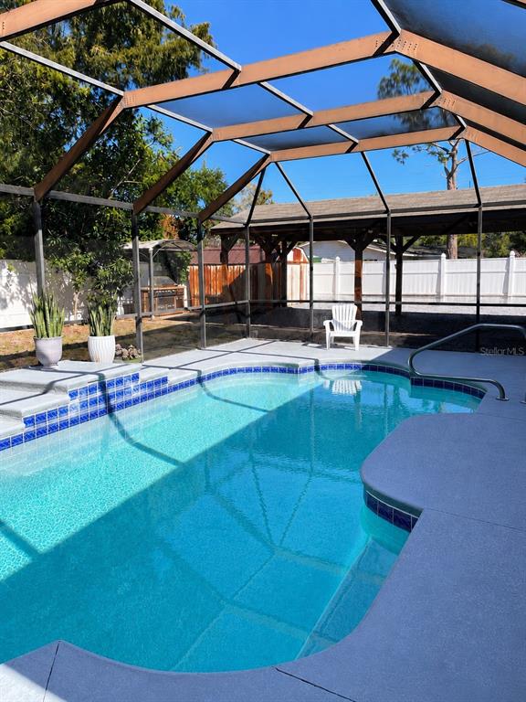 490 Water Road Ocala, FL 34472 - Photo 2 of 12 a patio with a table and chairs under an umbrella