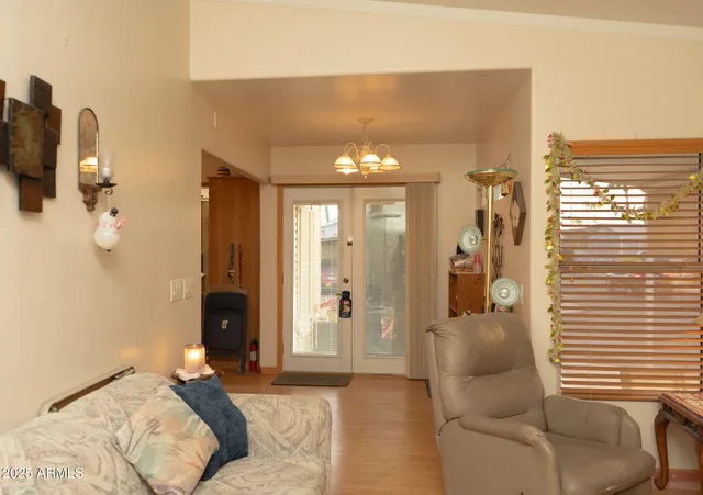 a view of hall way with furniture and chandelier