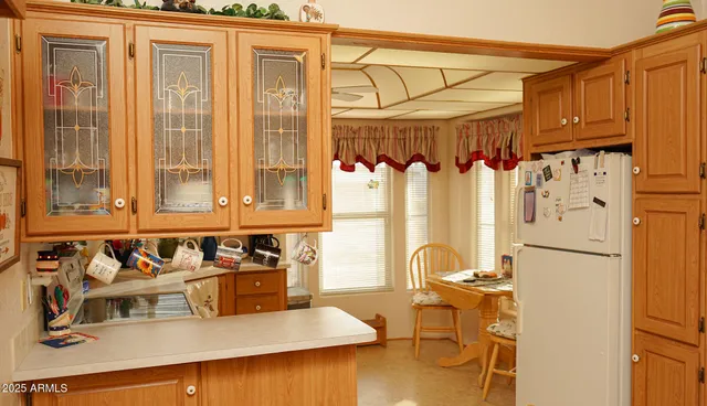 a kitchen with a refrigerator and a stove