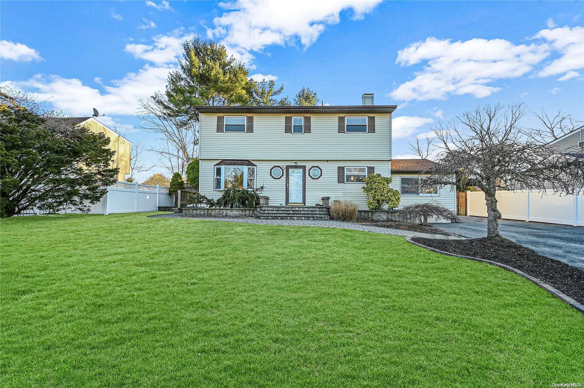 22 Saxon Road Centereach, NY 11720 - Photo 1 of 1 a front view of a house with garden