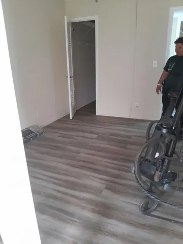 a view of a room with wooden floor