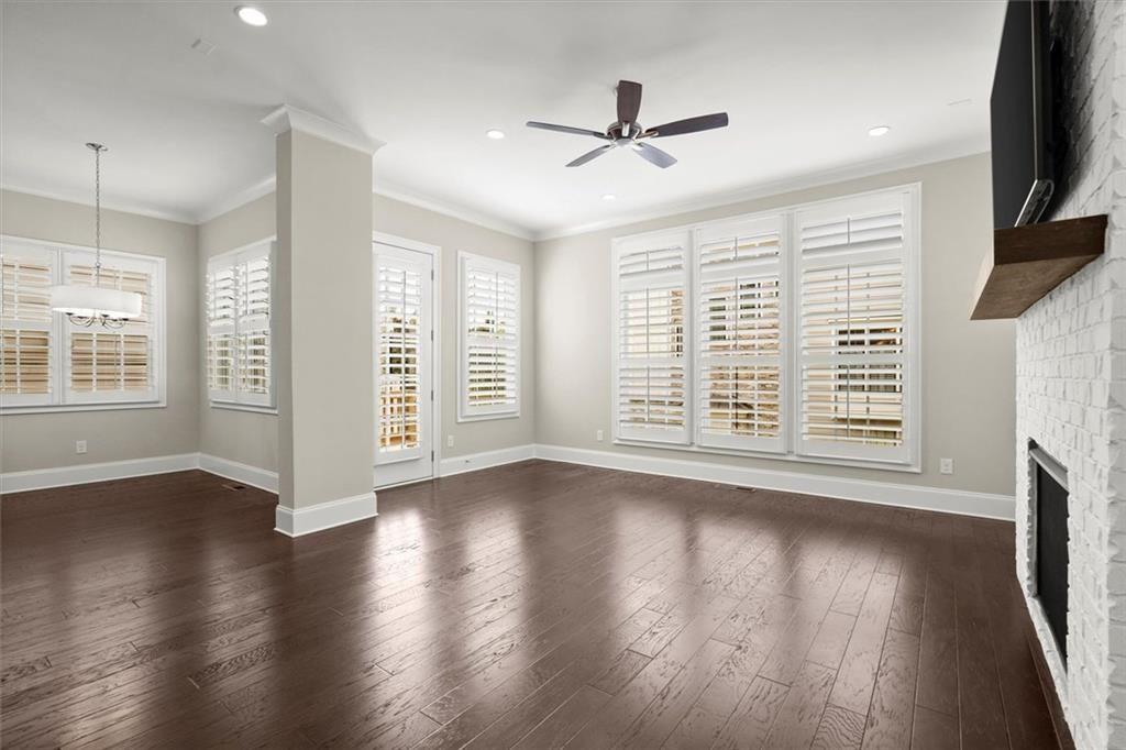 293 Thompson Street Alpharetta, GA 30009 - Photo 12 of 71 a view of an empty room with wooden floor and a window