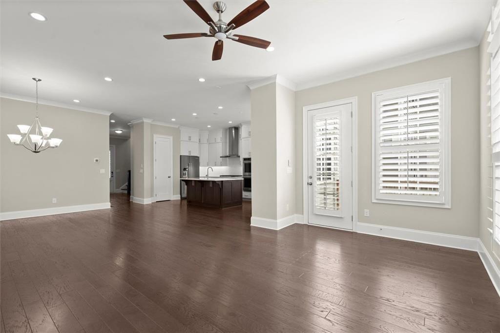 293 Thompson Street Alpharetta, GA 30009 - Photo 13 of 71 a view of an empty room with a window and wooden floor