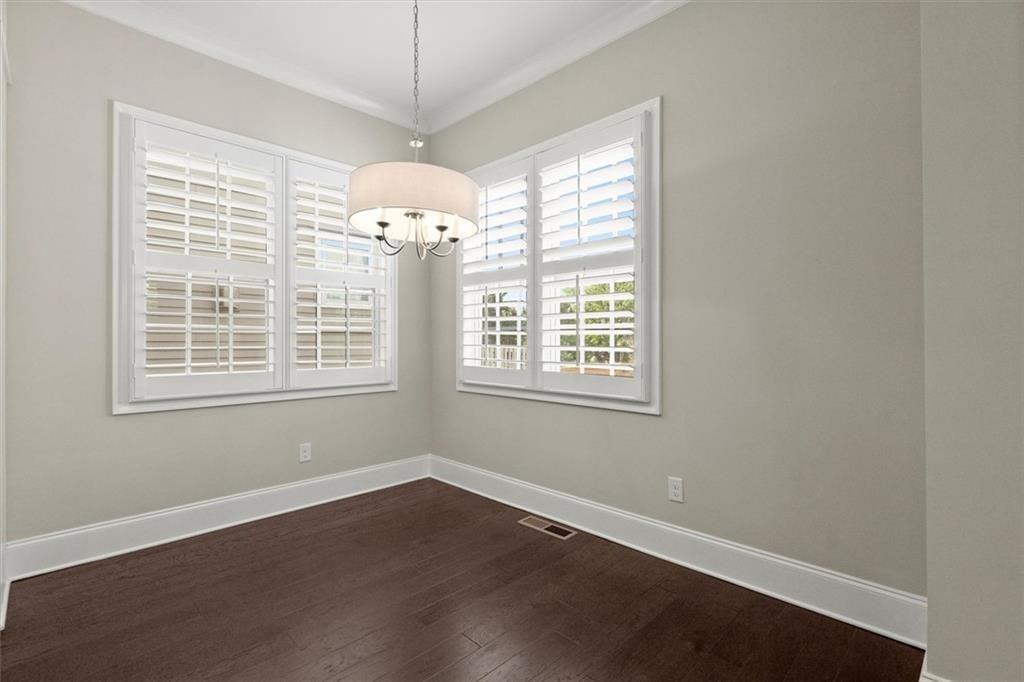 293 Thompson Street Alpharetta, GA 30009 - Photo 16 of 71 an empty room with wooden floor and windows