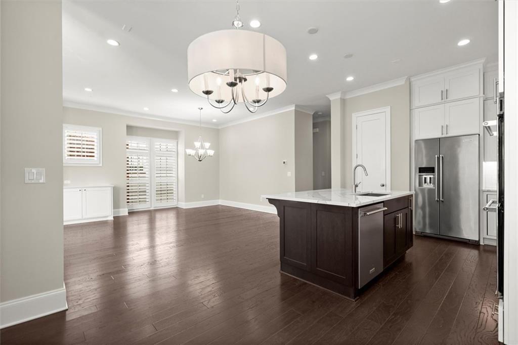 293 Thompson Street Alpharetta, GA 30009 - Photo 19 of 71 an open kitchen with a refrigerator and wooden floor