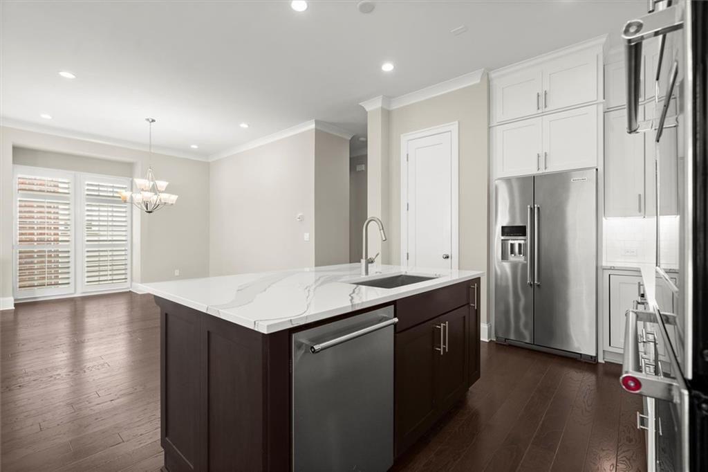 293 Thompson Street Alpharetta, GA 30009 - Photo 20 of 71 a kitchen with stainless steel appliances granite countertop a sink a refrigerator and a stove