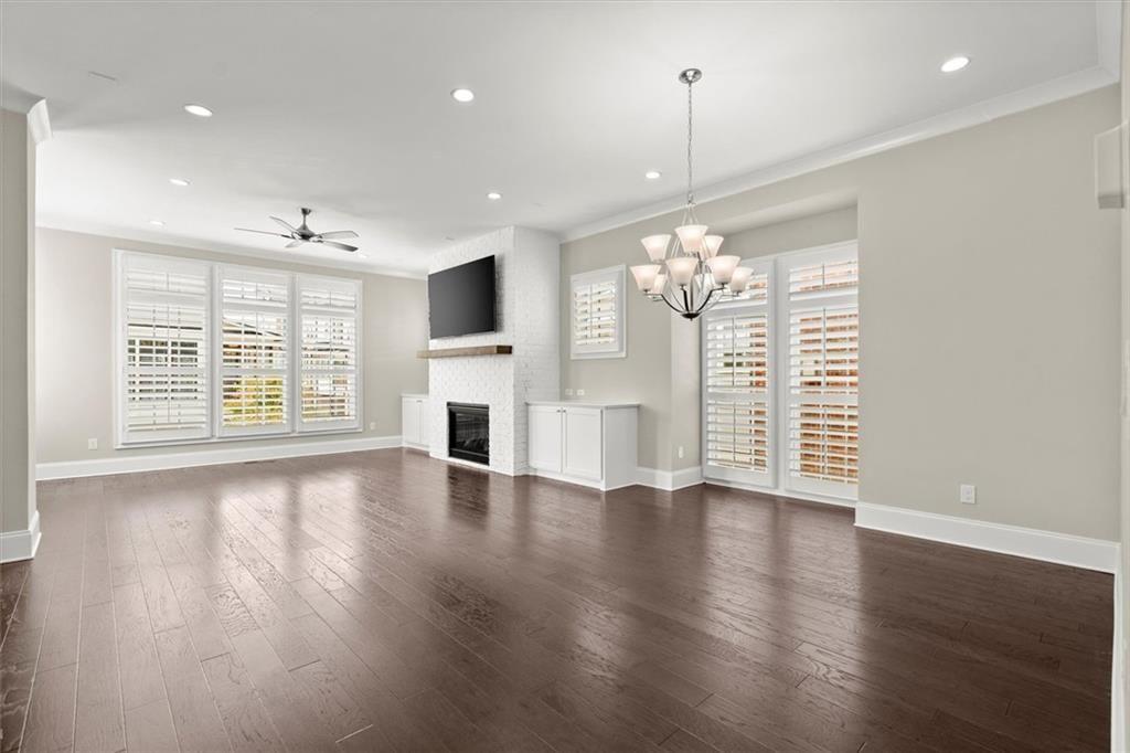 293 Thompson Street Alpharetta, GA 30009 - Photo 2 of 71 an empty room with wooden floor large windows and a chandelier