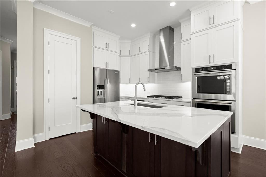 293 Thompson Street Alpharetta, GA 30009 - Photo 21 of 71 a kitchen with stainless steel appliances a sink stove and refrigerator