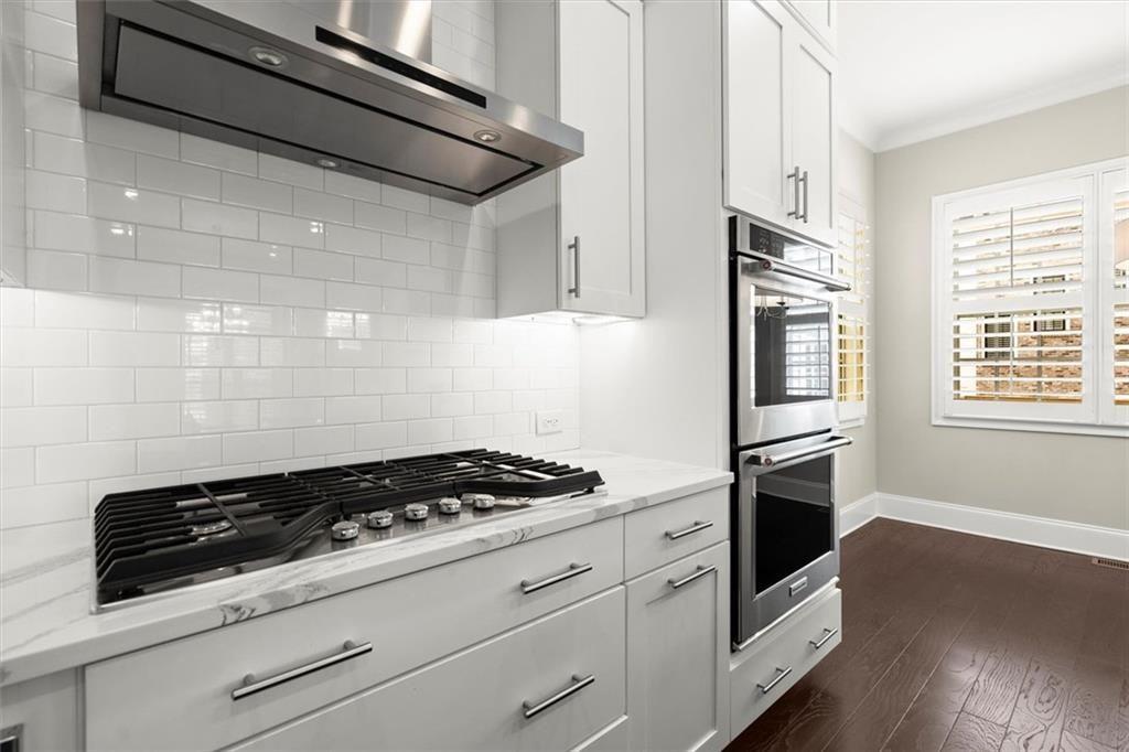 293 Thompson Street Alpharetta, GA 30009 - Photo 22 of 71 a kitchen with granite countertop cabinets and steel stove top oven