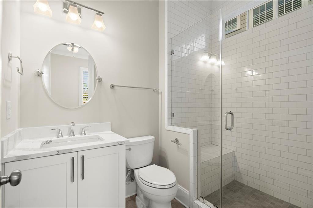 293 Thompson Street Alpharetta, GA 30009 - Photo 29 of 71 a bathroom with a toilet a sink a shower and mirror