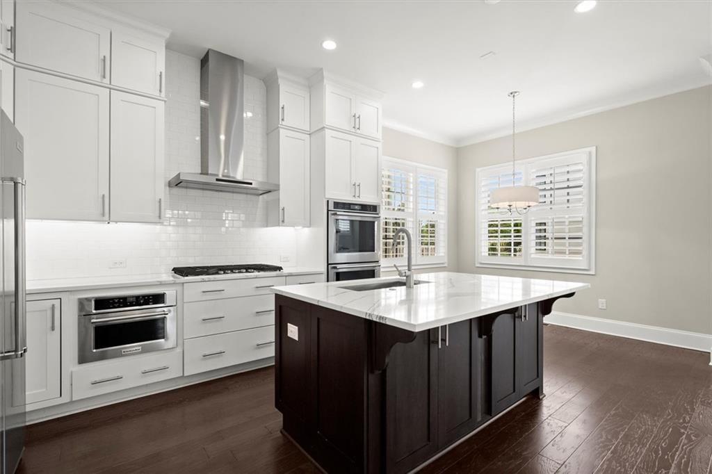 293 Thompson Street Alpharetta, GA 30009 - Photo 3 of 71 a kitchen with stainless steel appliances granite countertop a stove a sink and a microwave