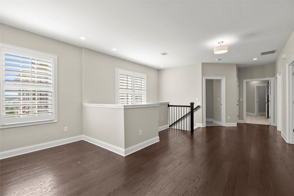 293 Thompson Street Alpharetta, GA 30009 - Photo 32 of 71 a view of an empty room with wooden floor and a window