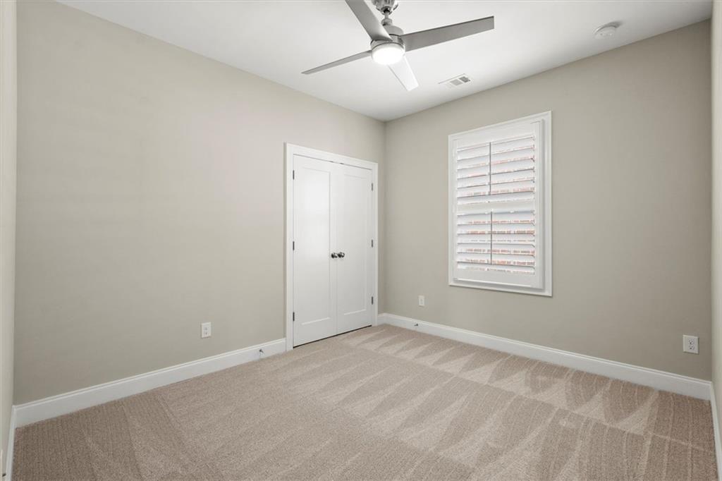 293 Thompson Street Alpharetta, GA 30009 - Photo 41 of 71 an empty room with a window and a fan