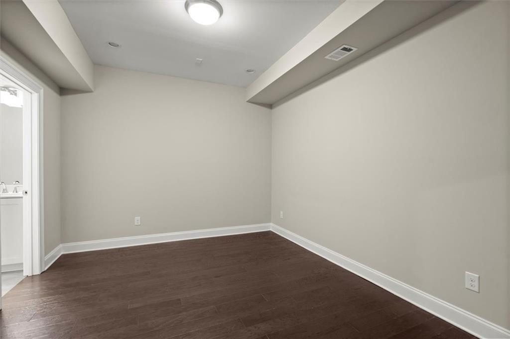 293 Thompson Street Alpharetta, GA 30009 - Photo 46 of 71 an empty room with wooden floor and windows