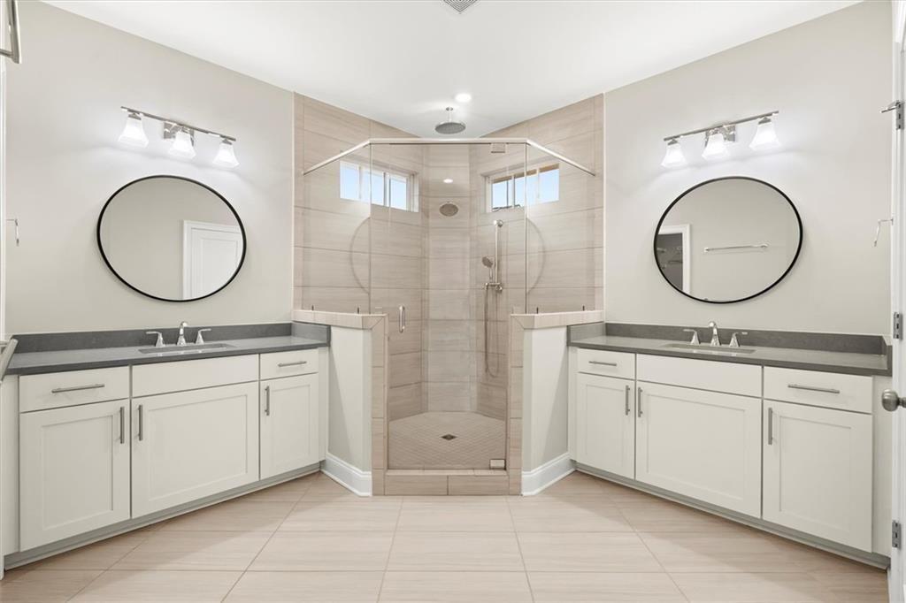 293 Thompson Street Alpharetta, GA 30009 - Photo 5 of 71 a bathroom with a double vanity sink mirror and a shower