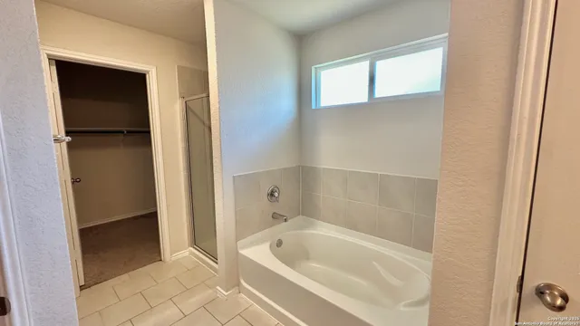 a bathroom with a tub and shower