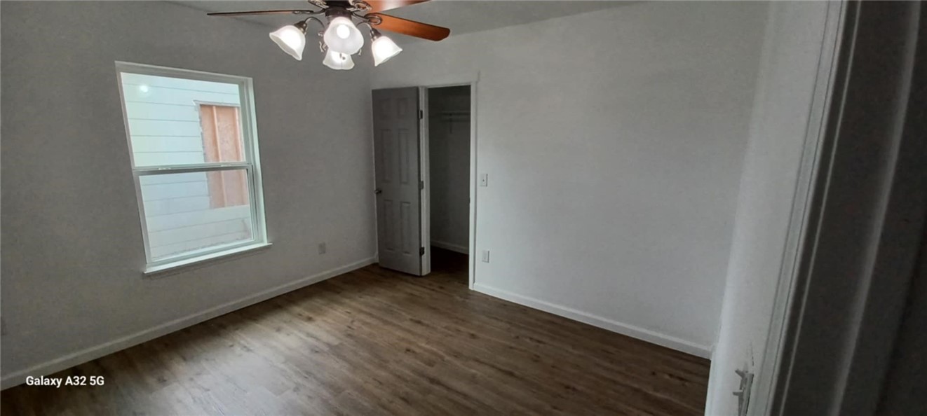 1005 Taylor Street Waco, TX 76704 - Photo 12 of 14 a view of an empty room with wooden floor and a window