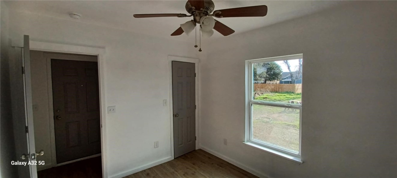 1005 Taylor Street Waco, TX 76704 - Photo 13 of 14 wooden floor in an empty room with a window