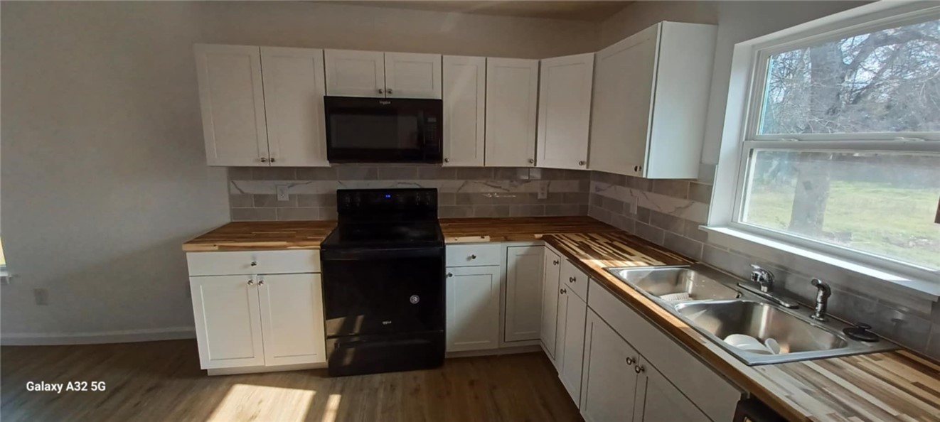 1005 Taylor Street Waco, TX 76704 - Photo 6 of 14 a kitchen with a sink and a stove top oven