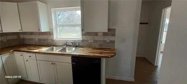 a kitchen with kitchen island granite countertop a stove a sink and a window