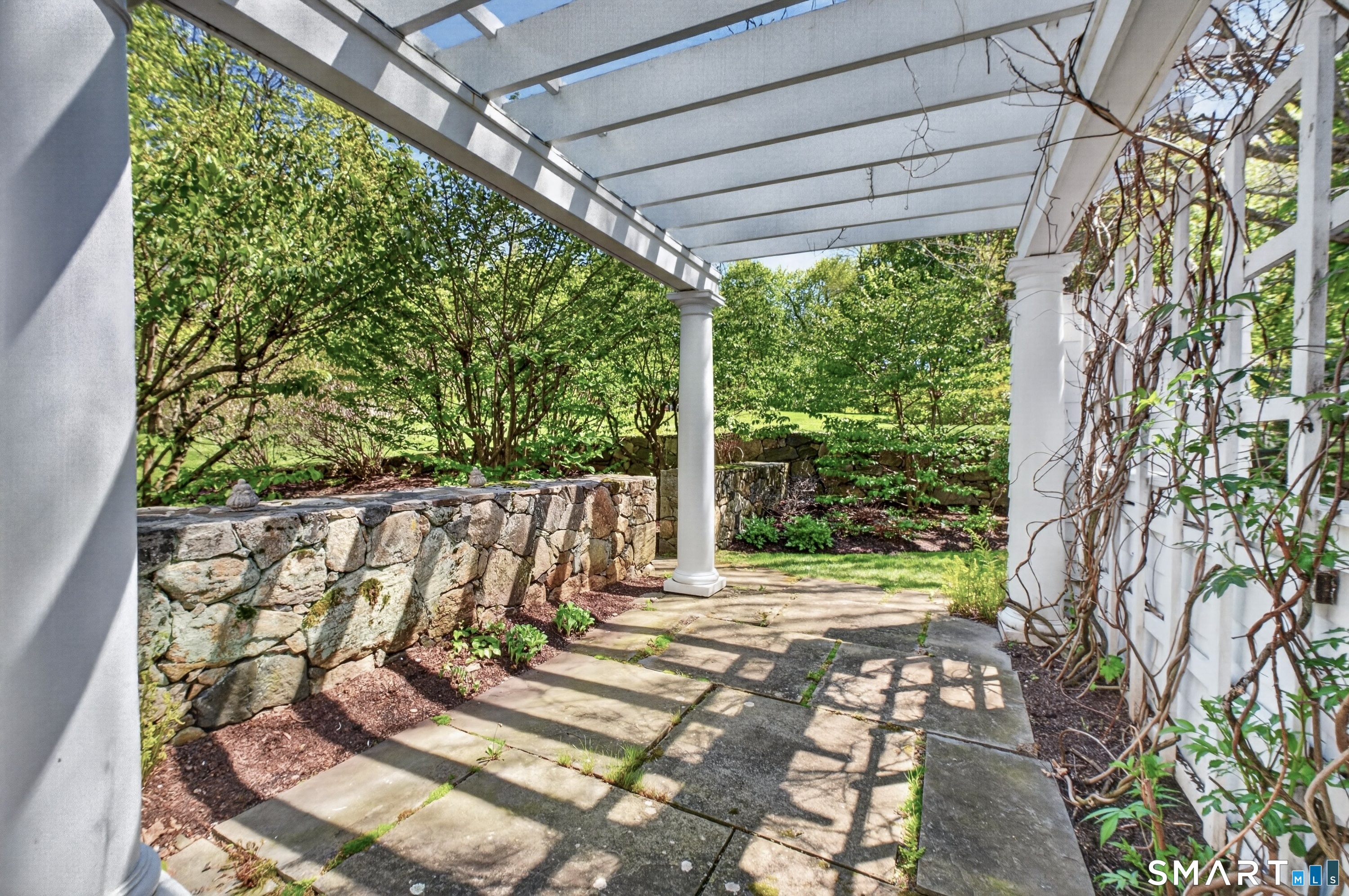 41 Peaceable Street Ridgefield, CT 06877 - Photo 28 of 40 a view of a patio with table and chairs potted plants with floor to ceiling window