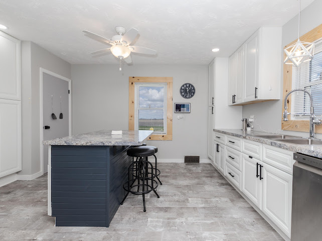 2950 County Road 1100 North Gridley, IL 61744 - Photo 15 of 38 a kitchen with granite countertop a sink a stove cabinets and a dining table