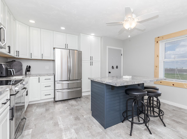 2950 County Road 1100 North Gridley, IL 61744 - Photo 16 of 38 a kitchen with white cabinets and stainless steel appliances