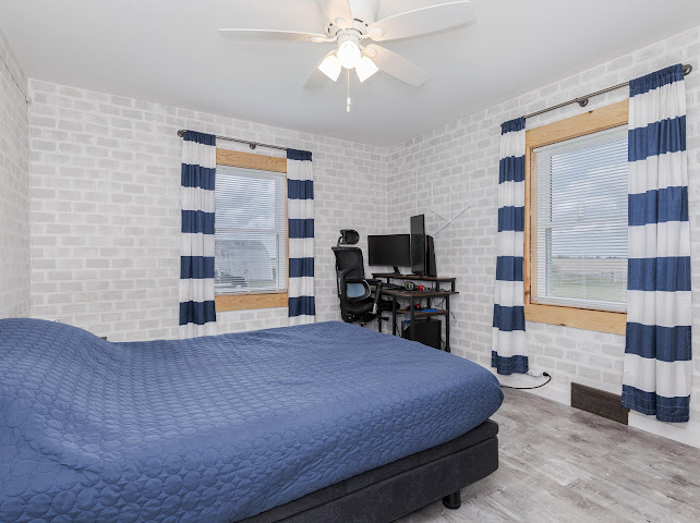 2950 County Road 1100 North Gridley, IL 61744 - Photo 23 of 38 a bedroom with a bed and a flat screen tv