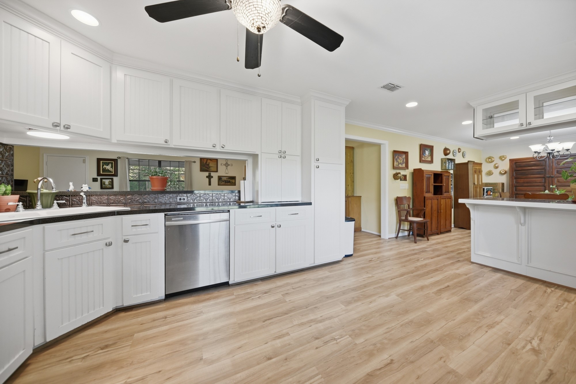 6201 Fm 389 Brenham, TX 77833 - Photo 36 of 50 a kitchen with stainless steel appliances granite countertop a refrigerator a sink dishwasher and white cabinets with wooden floor