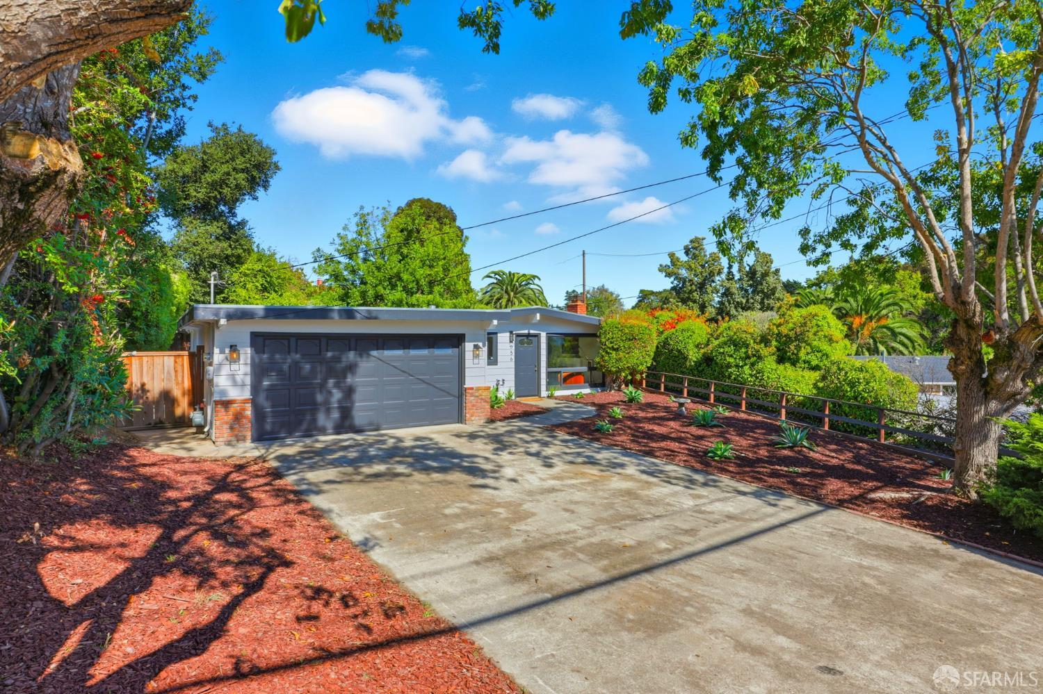 656 Pebble Drive El Sobrante, CA 94803 - Photo 11 of 41 a view of a backyard with plants and large tree