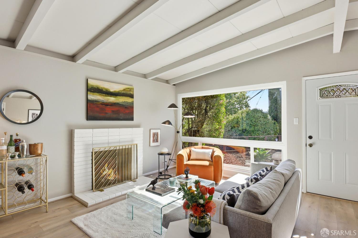 656 Pebble Drive El Sobrante, CA 94803 - Photo 12 of 41 a living room with furniture a fireplace and a flat screen tv