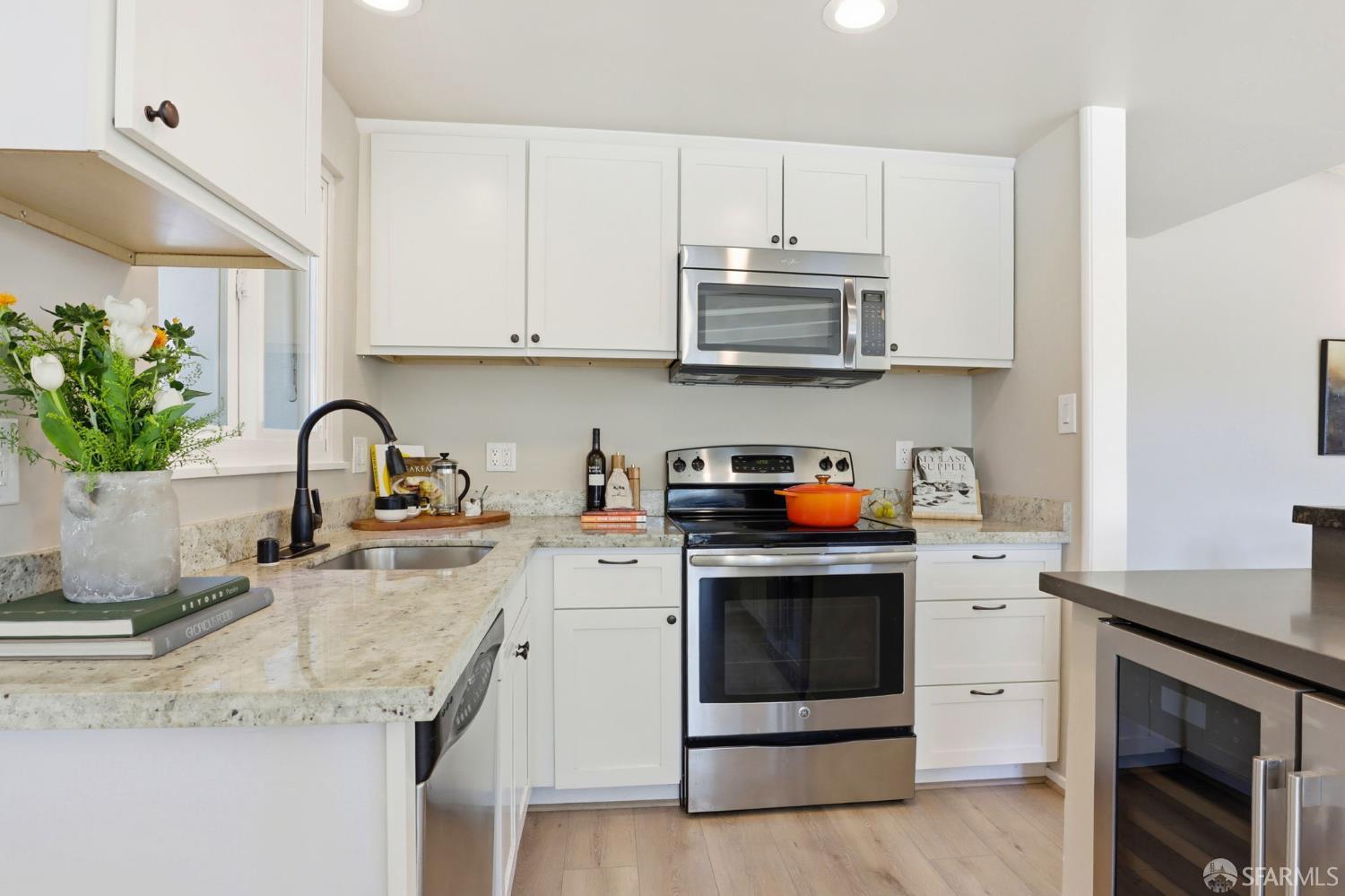 656 Pebble Drive El Sobrante, CA 94803 - Photo 20 of 41 a kitchen with stainless steel appliances granite countertop a sink stove and white cabinets