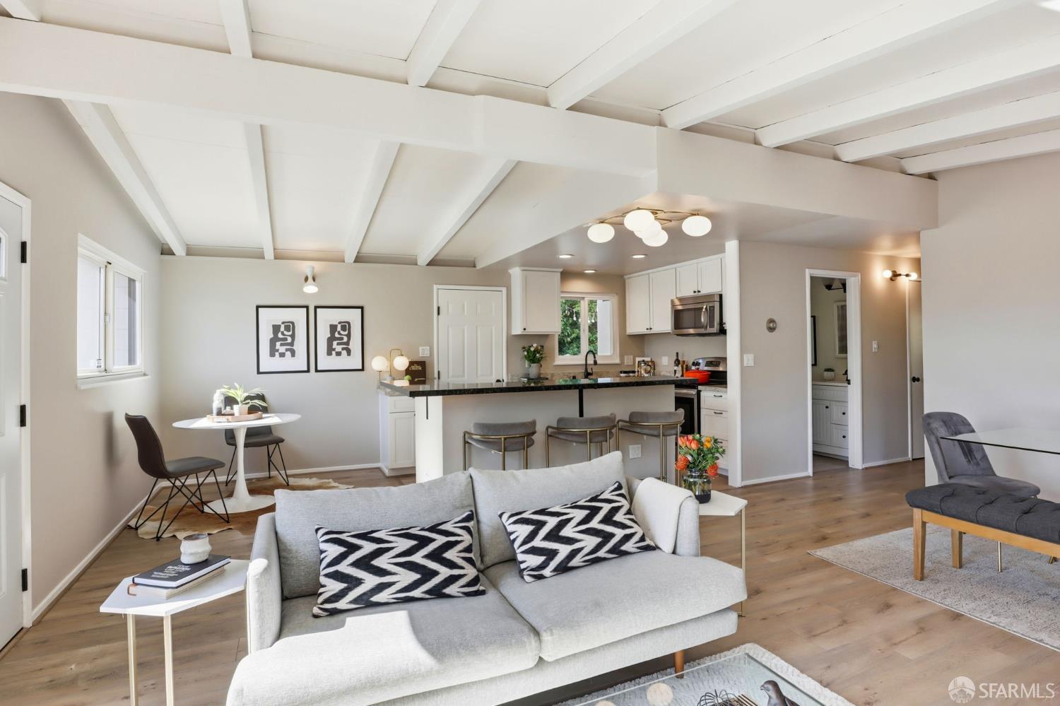 656 Pebble Drive El Sobrante, CA 94803 - Photo 3 of 41 a living room with furniture and a dining table with wooden floor