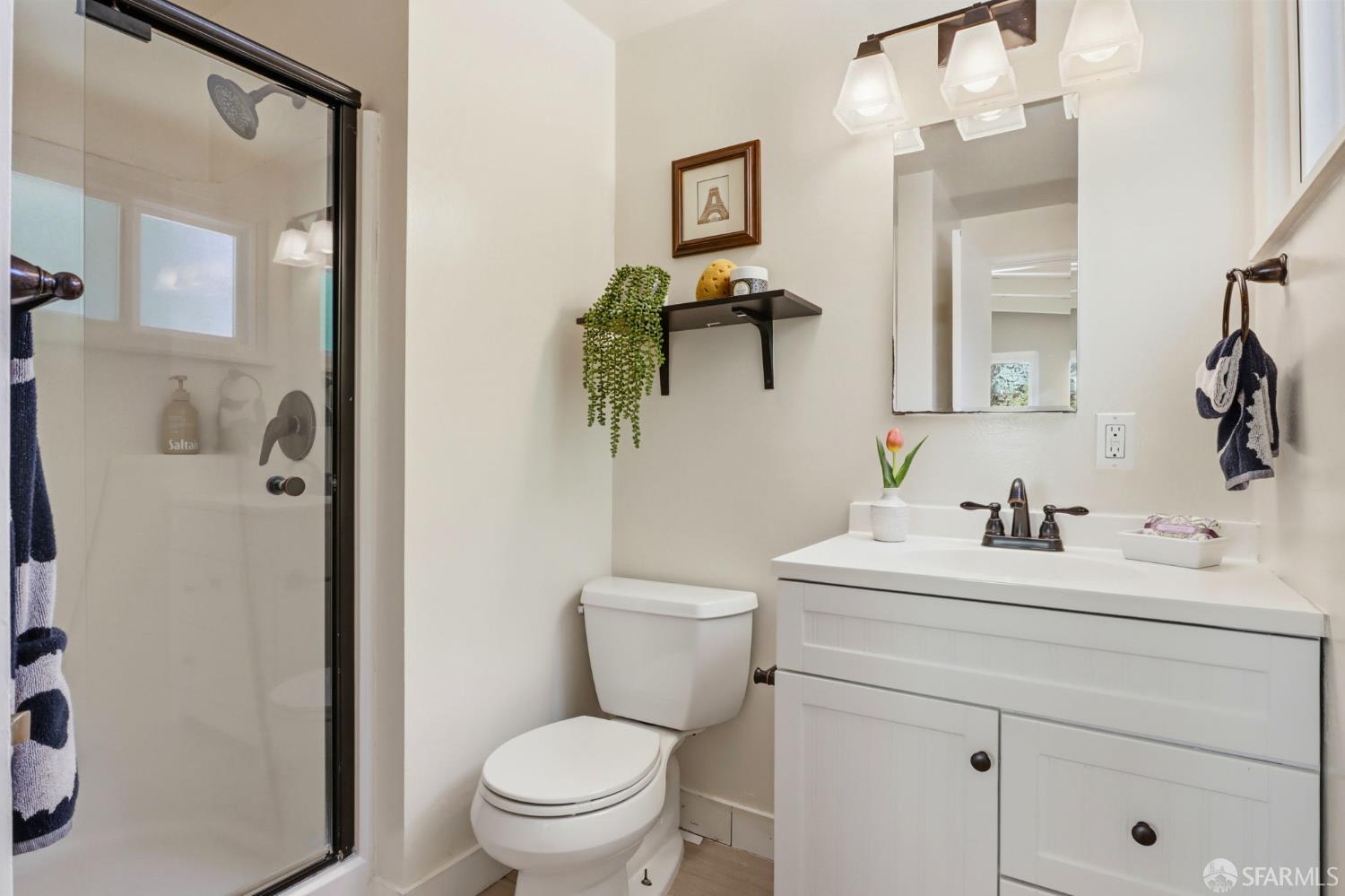 656 Pebble Drive El Sobrante, CA 94803 - Photo 7 of 41 a bathroom with a sink a toilet and shower a mirror