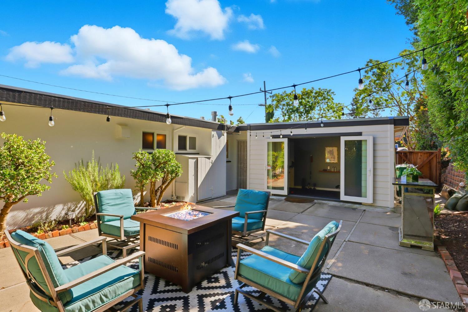 656 Pebble Drive El Sobrante, CA 94803 - Photo 8 of 41 a view of a patio with table and chairs with potted plants and wooden fence