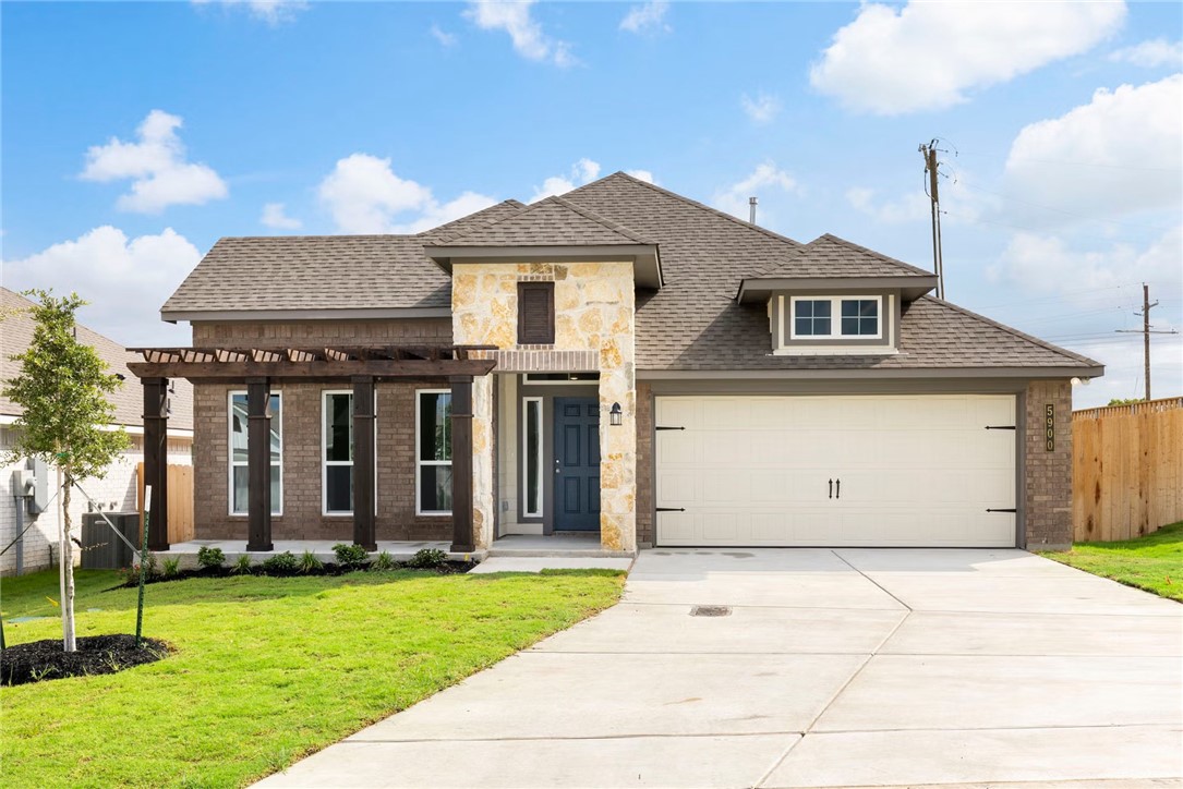 1910 Viva Road Bryan, TX 77807 - Photo 1 of 6 a front view of a house with a yard