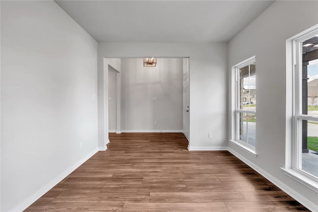1910 Viva Road Bryan, TX 77807 - Photo 4 of 6 a view of an empty room with wooden floor and window